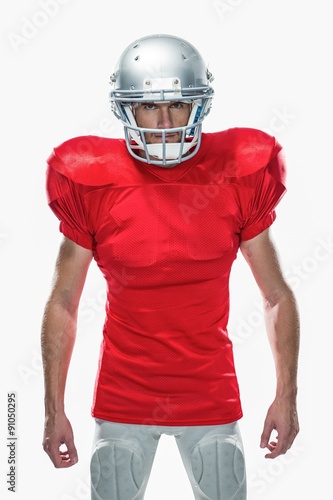 Portrait of serious American football player standing
