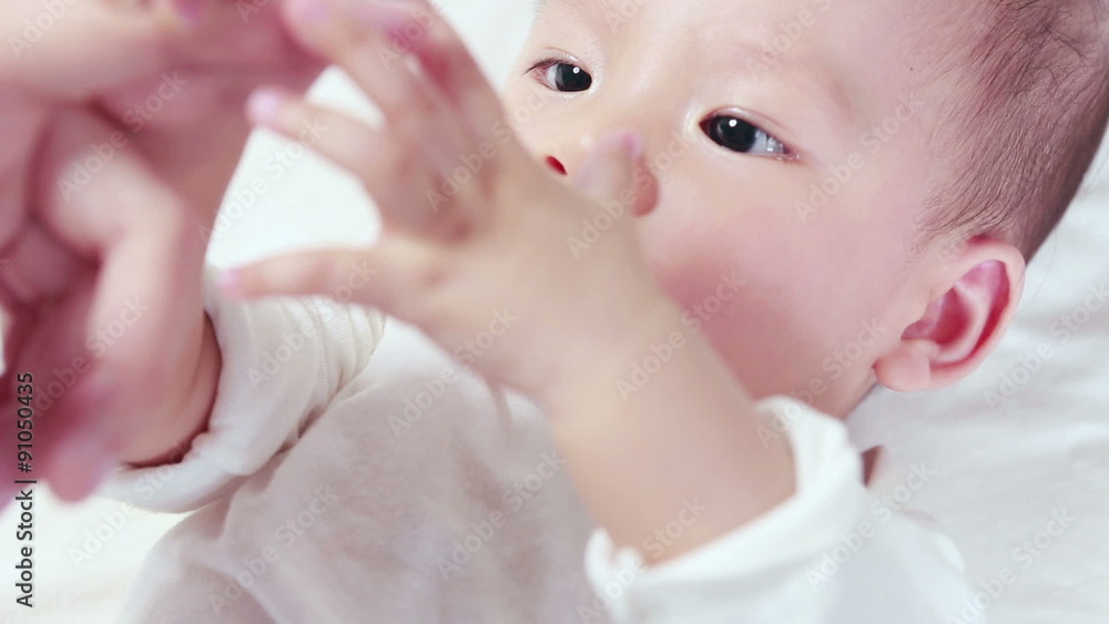 Mother holding a hand of her baby Mother holding a hand of her baby