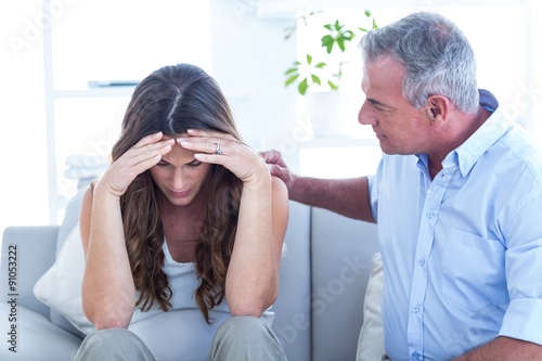 Psychiatrist advising pregenat woman in clinic photo