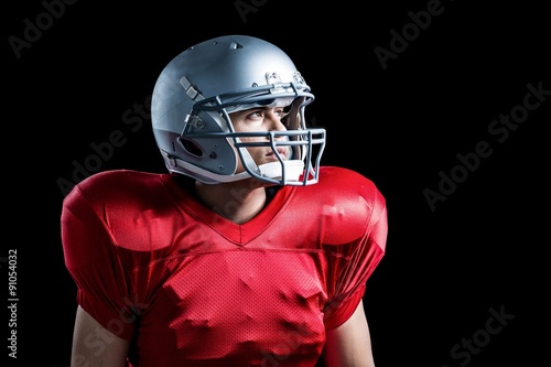 American football player looking away while standing