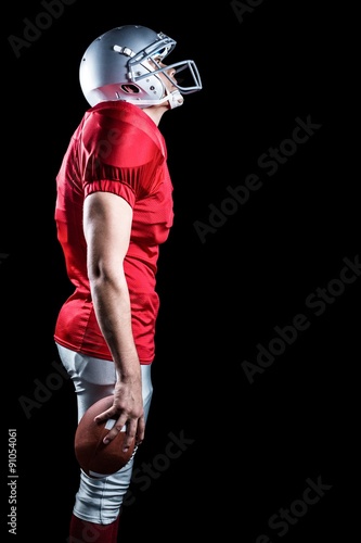 American football player looking up while standing