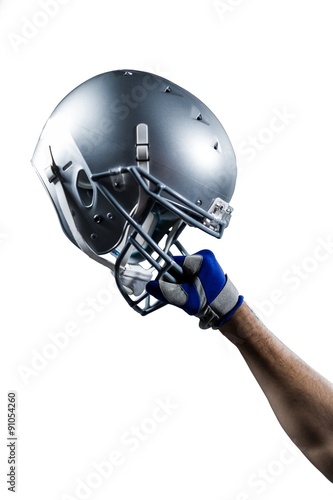 Cropped hand of sportsman holding helmet