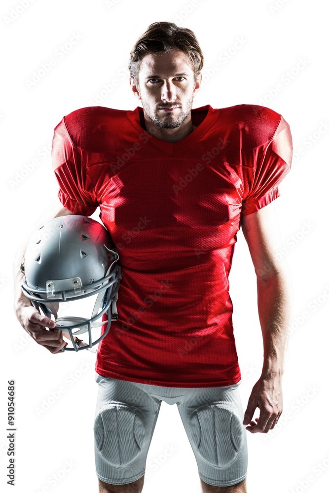 American football player in red jersey holding helmet
