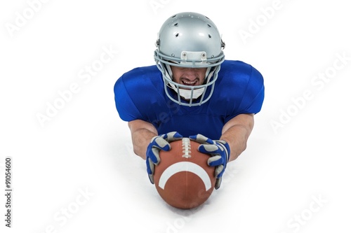 American football player reaching towards ball