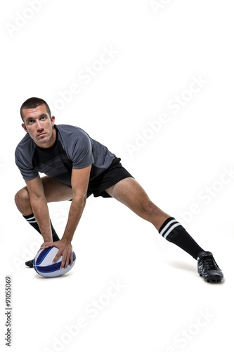 Sports player in black jersey stretching with ball