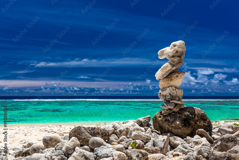 Stack of reef stones against sky and beach of Cook Islands Stack of reef stones against sky and beach of Cook Islands