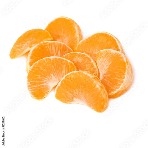 Pile of slice sections of tangerine isolated over the white