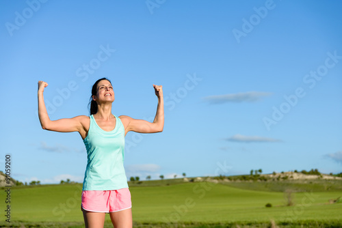 Woman celebrating fitness and running success
