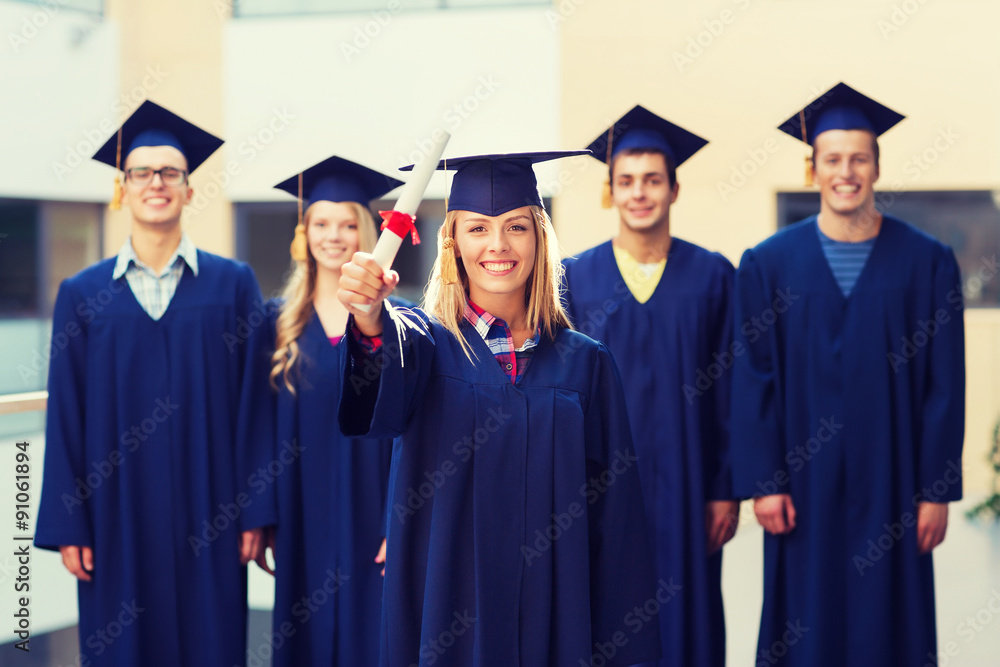 group of smiling students in mortarboards group of smiling students in mortarboards