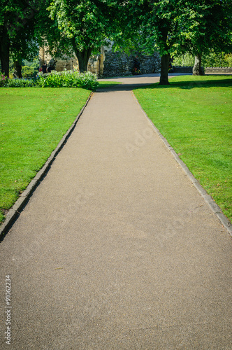 Stone path in a park through a lawn