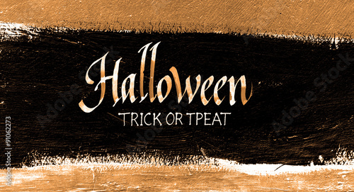 Trick or treat.typography halloween poster with calligraphy on the wall texture. Iinvitation banner. Hand lettering on the grunge background. photo