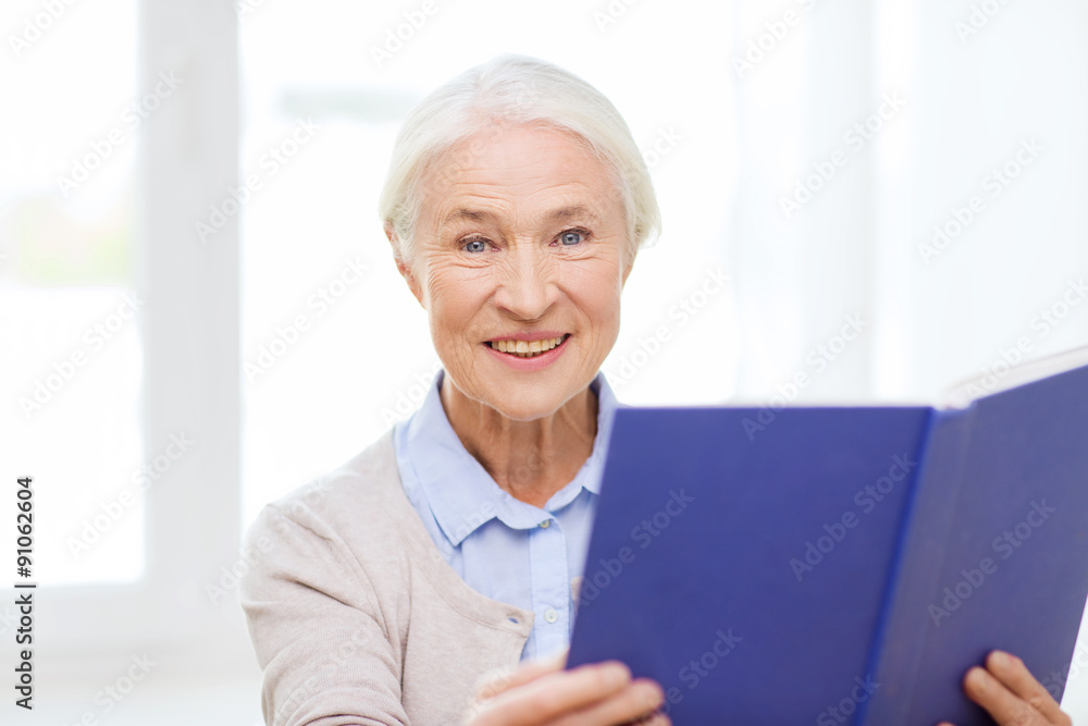happy smiling senior woman reading book at home happy smiling senior woman reading book at home
