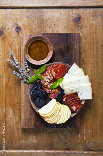 Snack on a clay plate and wooden background. rural style. prosci photo