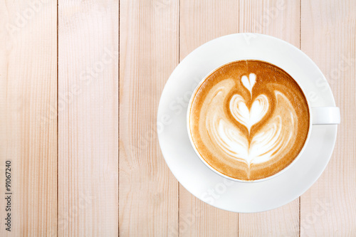 Top view latte art coffee on wood background