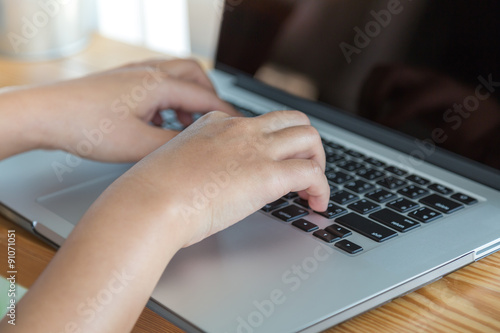 Closeup of business woman hand typing on laptop keyboard