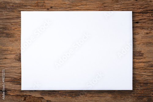 Obraz na płótnie white paper on old wood table w salonie