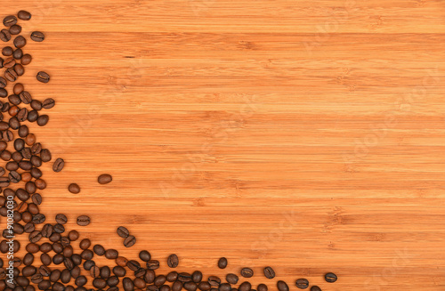 Coffee beans corner over bamboo wood background