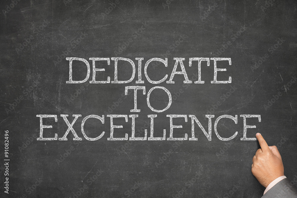 Obraz premium Dedicate to excellence text on blackboard