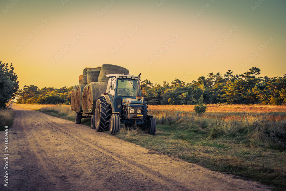 Fototapeta premium Old tractor with hay bales