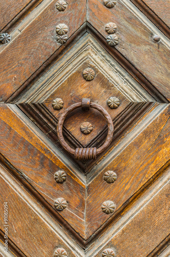 Fotografie Iron  knocker on the old wooden door
