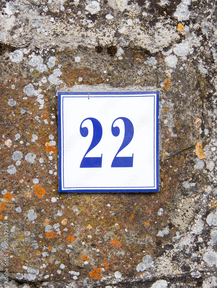 Number twenty two on the grey stone wall Number twenty two on the grey stone wall
