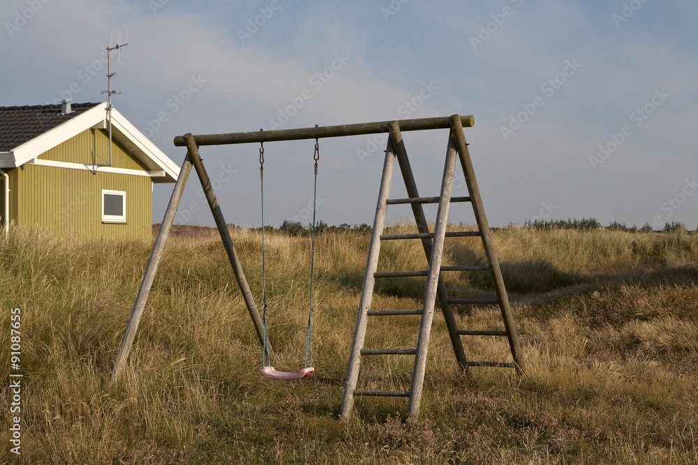 Childhood Memories. Play swings frame the distant sand dunes. There are no fences and the subtext is of summer, freedom and childhood adventures. Childhood Memories. Play swings frame the distant sand dunes. There are no fences and the subtext is of summer, freedom and childhood adventures.