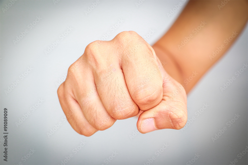 Male hand showing clutched in his fist isolated on white background Male hand showing clutched in his fist isolated on white background