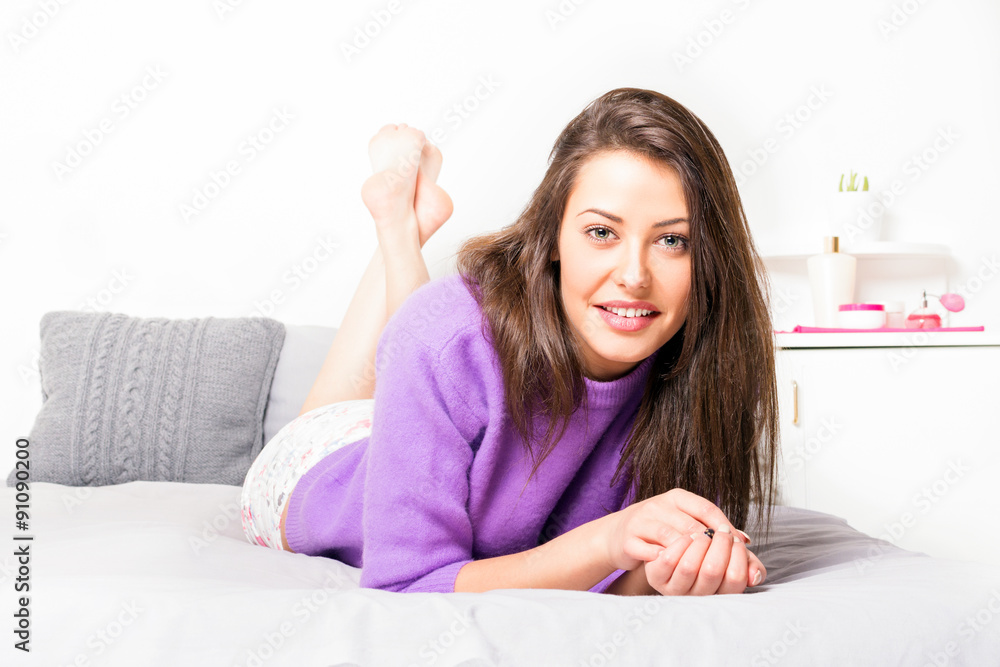 Young woman relaxing at home lying in bed Young woman relaxing at home lying in bed