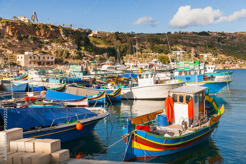 Port of Mgarr on the small island of Gozo, Malta. Traditional maltese colorful painted fishing boat.