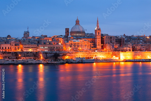 Valletta seafront skyline view as seen from Sliema  Malta. Illuminated historical buildings after sunset.