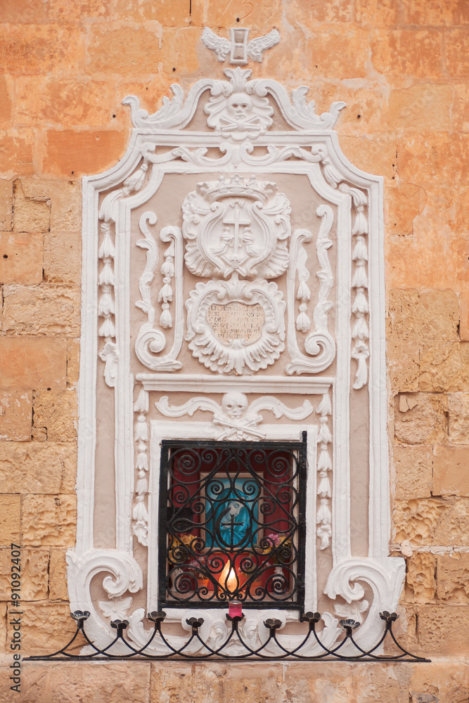 Religious icon of Madonna on a house facade in Mdina, Malta.