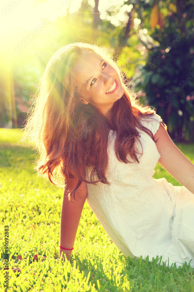 Obraz premium Beauty romantic teenage girl sitting on green grass outdoor
