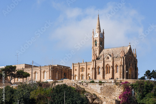 Mgarr harbor with view on church to Our Lady of Lourdes. Gozo, Malta.