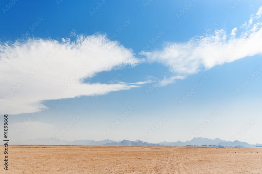 Beautiful Desert Landscape of Egypt. Yellow sand, mountains, clouds.