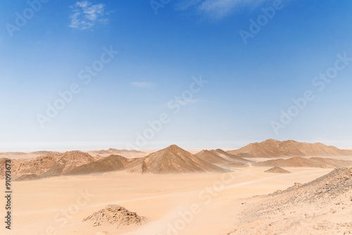 Desert Landscape of Egypt. Yellow sand, mountains, clouds.