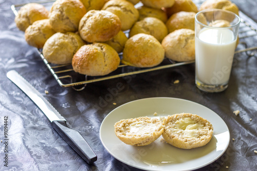 baked bread and buns and a glass of milk