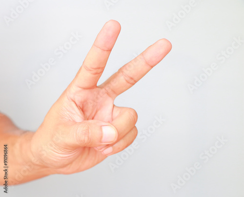 Hand showing two fingers isolated on white background