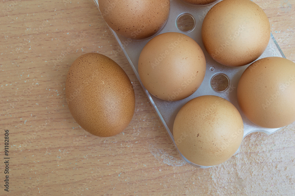 Chicken egg on wood and chicken egg in panel eggs on wood backgr Chicken egg on wood and chicken egg in panel eggs on wood backgr
