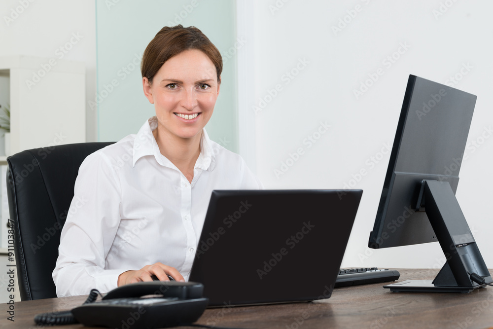 Businesswoman Working On Laptop And Desktop Computer Businesswoman Working On Laptop And Desktop Computer