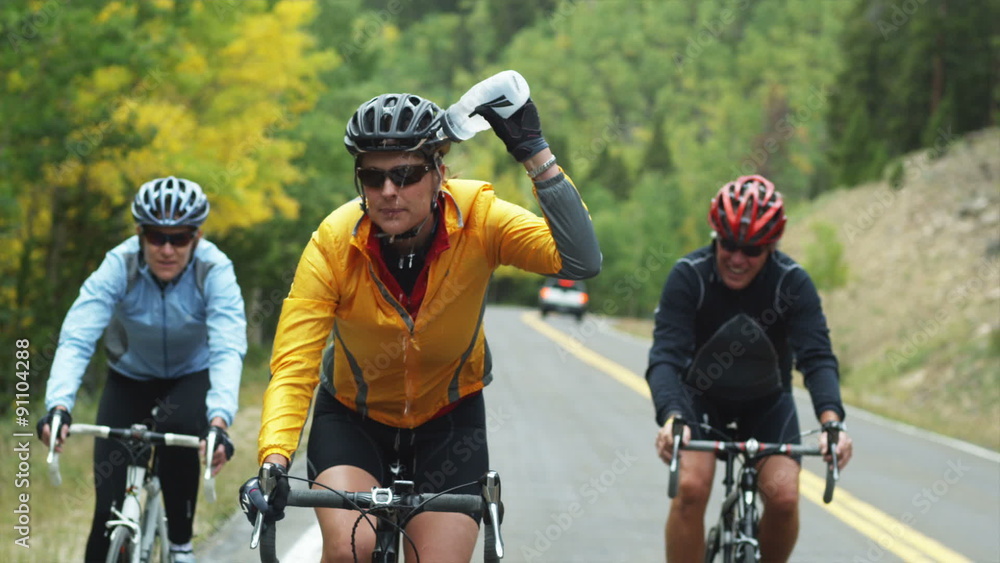 cyclists cooling off with a water bottle cyclists cooling off with a water bottle