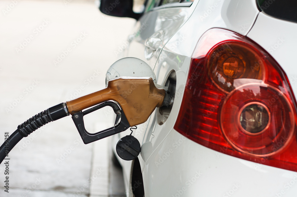 To fill the machine with fuel. Car fill with gasoline at a gas s To fill the machine with fuel. Car fill with gasoline at a gas s