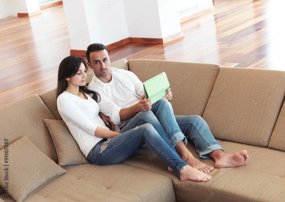 couple at modern home using tablet computer couple at modern home using tablet computer