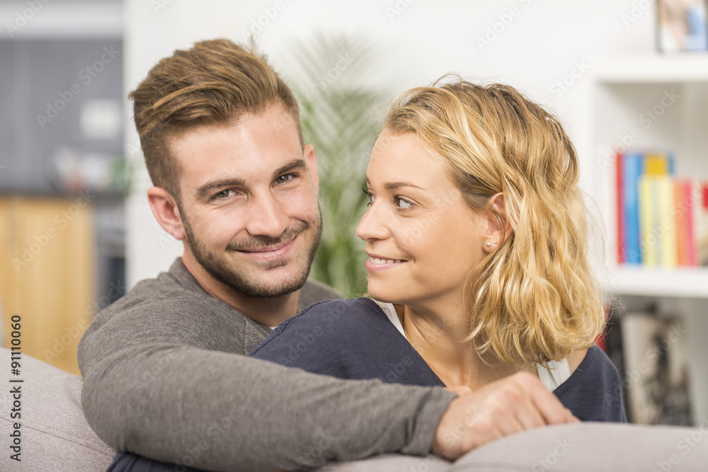 cheerful couple relaxing in sofa at home cheerful couple relaxing in sofa at home