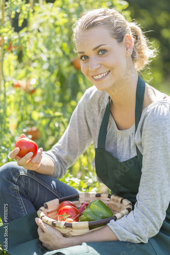 Fotografie young woman gardening in kitchen garden