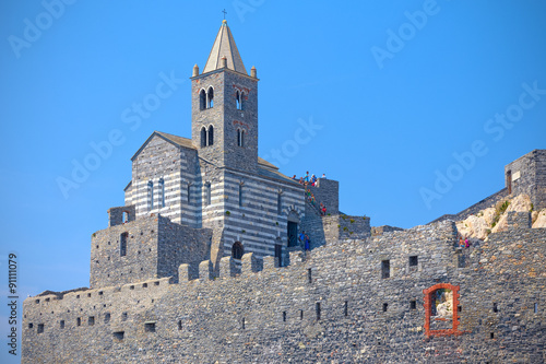 Church of San Pietro perched on its walls  seen from below sea
