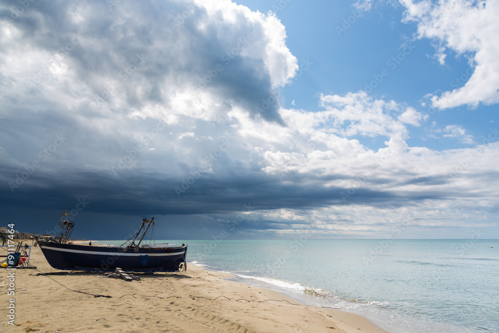 Blue sea and clouds and a boat