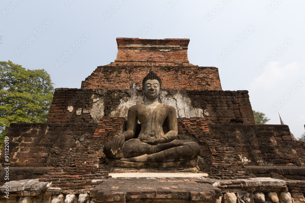 Buddha meditation in front of broken pagoda Buddha meditation in front of broken pagoda