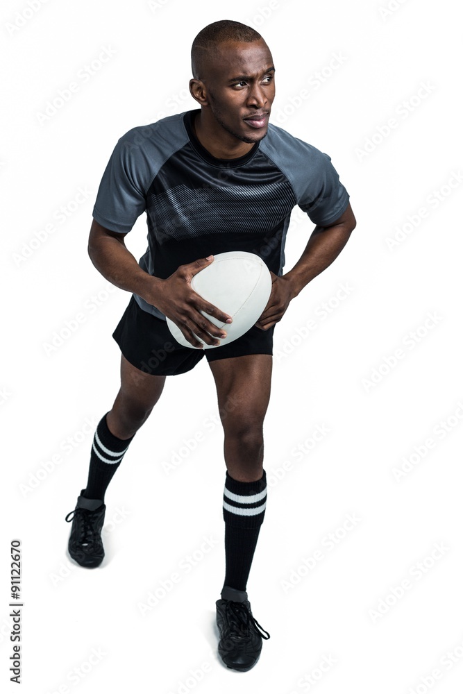 Confident rugby player running while holding ball