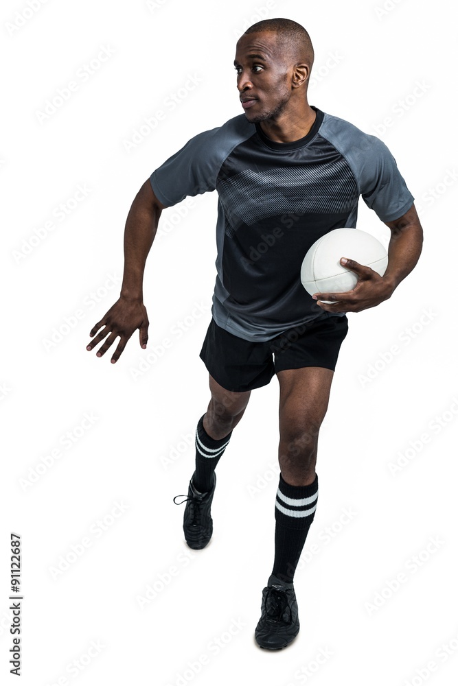 Sportsman running while holding rugby ball