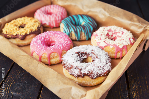 Fototapeta Fresh homemade donuts with various toppings